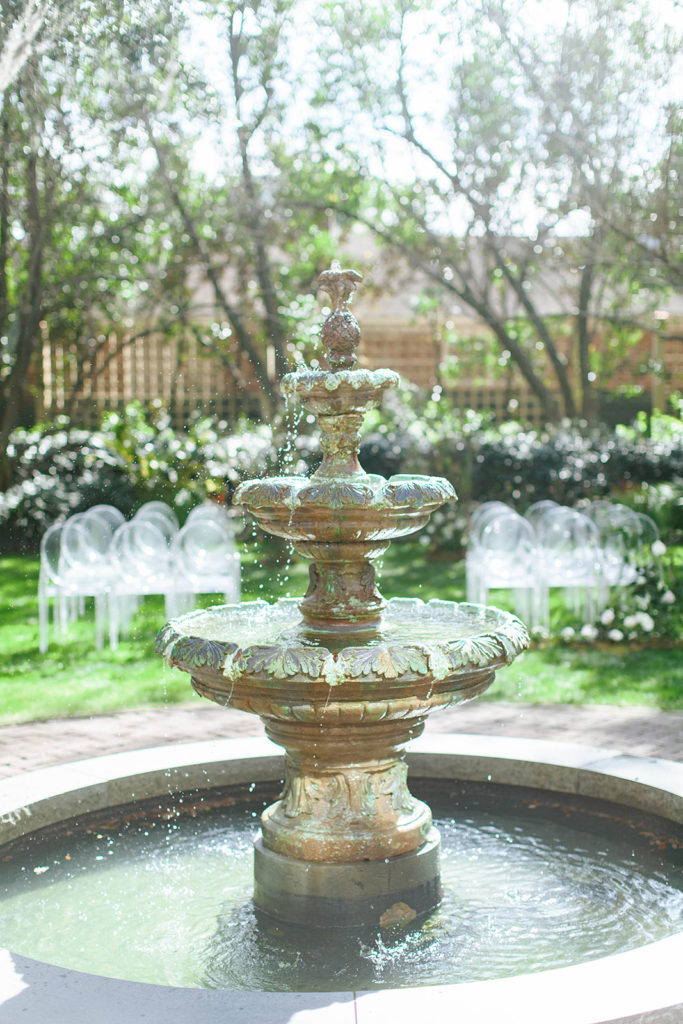 outdoor ceremony venue with florals and fountain