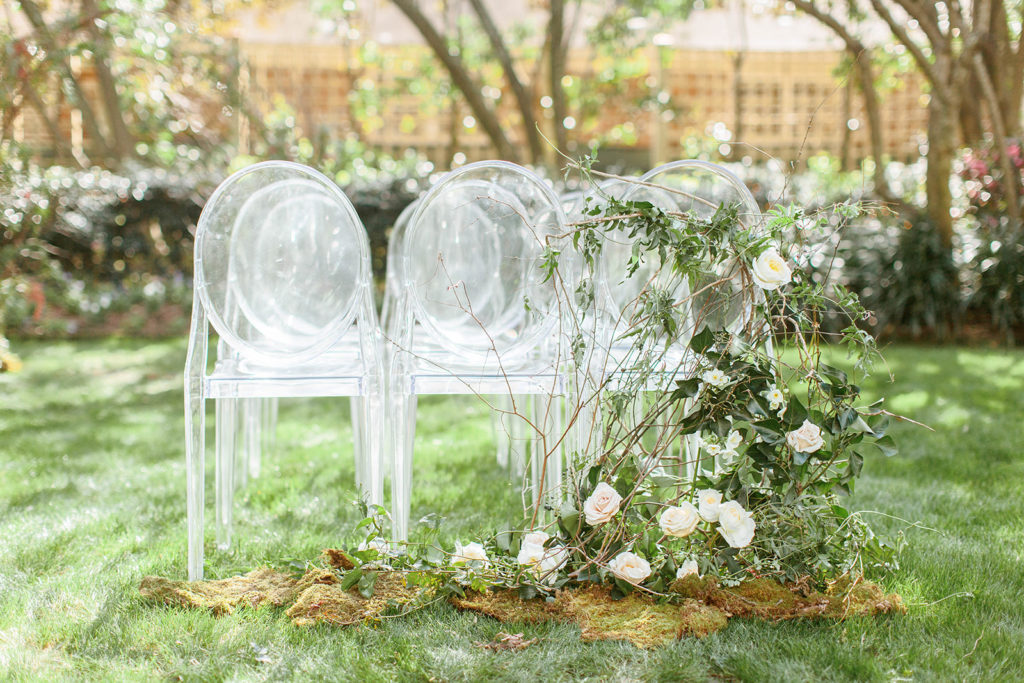 ceremony florals with clear chairs