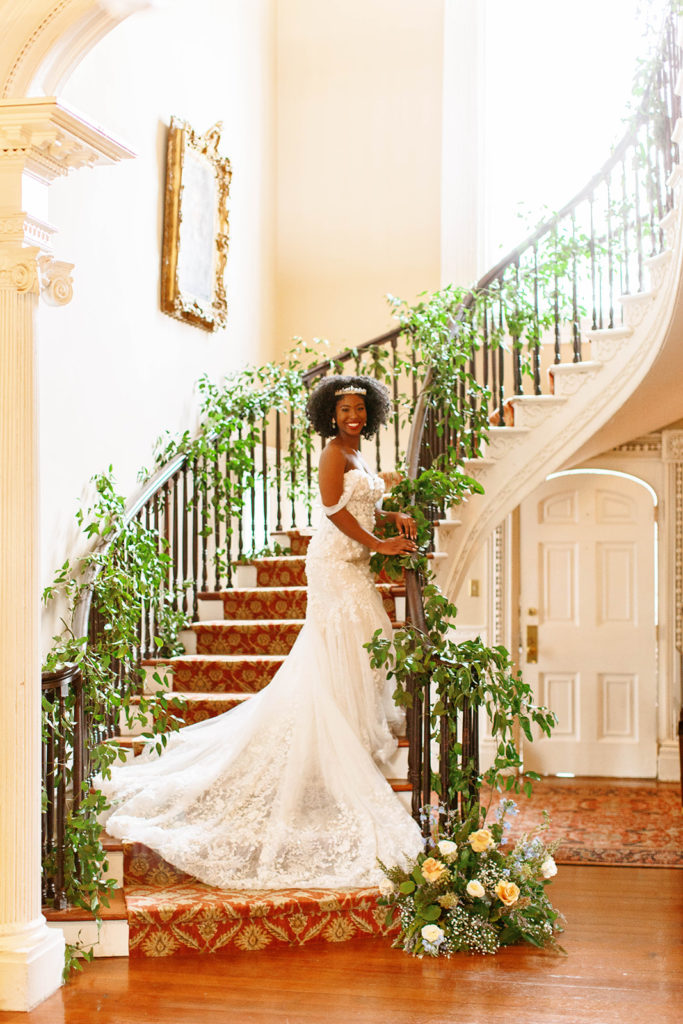 bridal portrait on grand staircase with florals